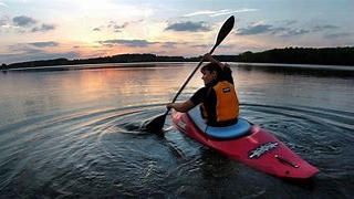 picture of man kayaking in the sunset