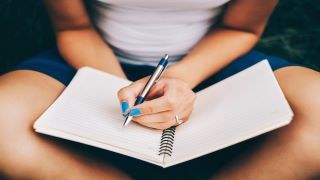 Woman writing in a Journal